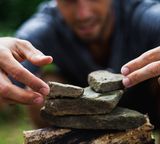 man build stones zen pile